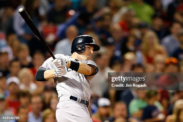 Stephen Drew of the New York Yankees doubles in a run in the fourth inning against the Boston Red Sox at Fenway Park on August 3, 2014 in Boston,...