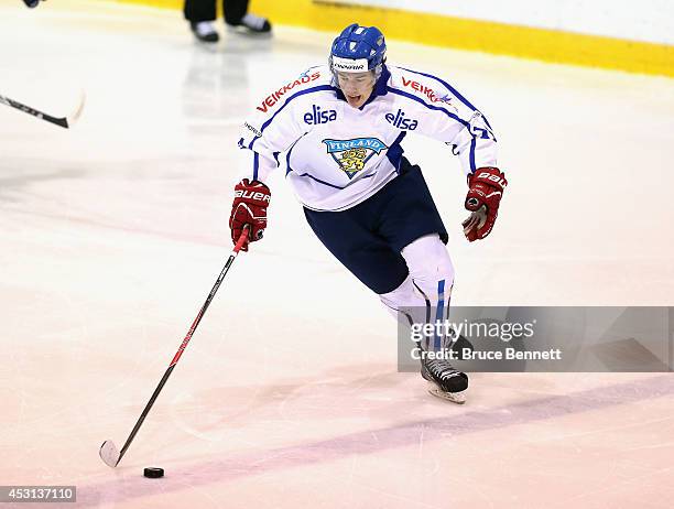 Juho Lammikko of Team Finland skates against USA Blue during the 2014 USA Hockey Junior Evaluation Camp at the Lake Placid Olympic Center on August...