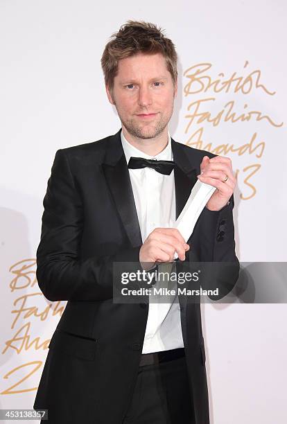 Christopher Bailey poses in the winners room at the British Fashion Awards 2013 at London Coliseum on December 2, 2013 in London, England.