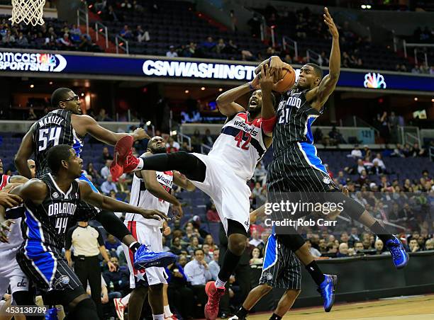 Maurice Harkless of the Orlando Magic blocks a shot by Nene Hilario of the Washington Wizards during the first half at Verizon Center on December 2,...