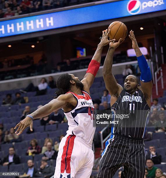 Washington Wizards power forward Nene Hilario blocks the shot of Orlando Magic power forward Glen Davis during the first half of their game played at...