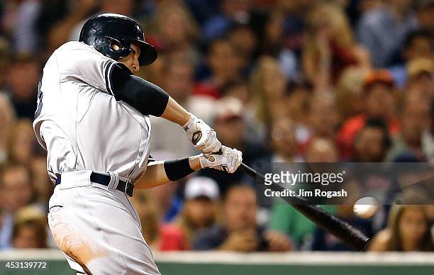 Stephen Drew of the New York Yankees singles in two runs in the fifth inning against the Boston Red Sox at Fenway Park on August 3, 2014 in Boston,...