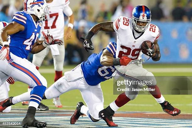 Defensive end Bryan Johnson of the Buffalo Bills tackles running back Michael Cox of the New York Giants at the 2014 NFL Hall of Fame Game at Fawcett...