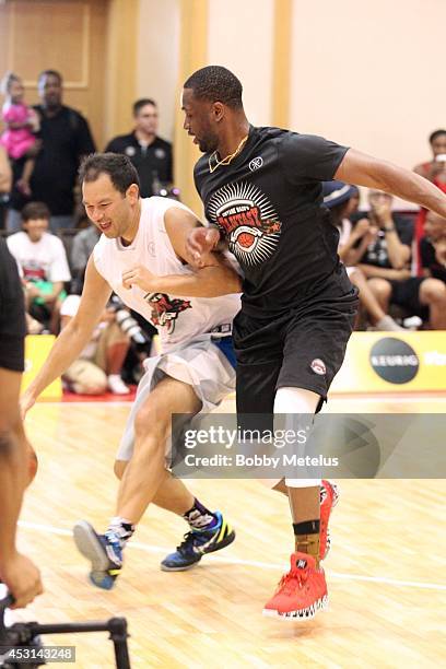 Dwyane Wade plays against campers during Dwyane Wade's Fourth Annual Fantasy Basketball Camp at Westin Diplomat on August 3, 2014 in Hollywood,...