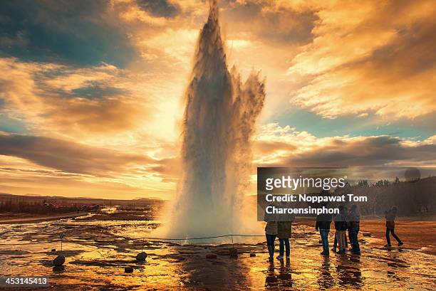 sunset at strokkur geyser - geyser ストックフォトと画像