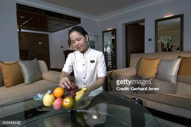 Maid lays out a bowl of fruit in a suite on the 17th floor at the Grand Hyatt Hotel. The floor, called the Grand Club, is considered as a mini hotel...