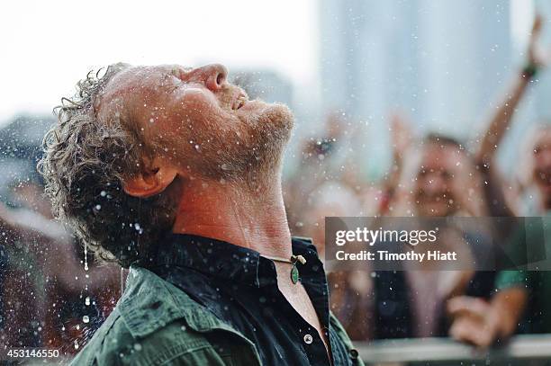 Glen Hansard braves the ran with fans during his set at Lollapalooza 2014 at Grant Park on August 3, 2014 in Chicago, Illinois.