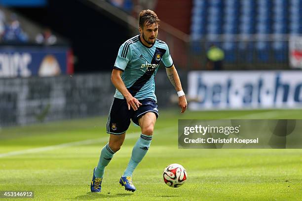 Carl Jenkinson of West Ham United runs with the ball during the match between FC Malaga and West Ham United as part of the Schalke 04 Cup Day at...