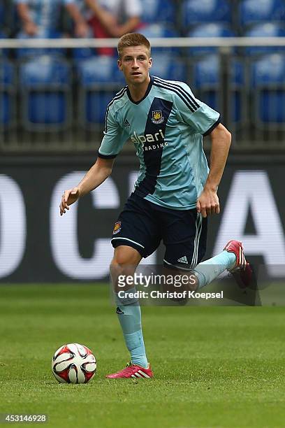 Reece Burke of West Ham United runs with the ball during the match between FC Malaga and West Ham United as part of the Schalke 04 Cup Day at...