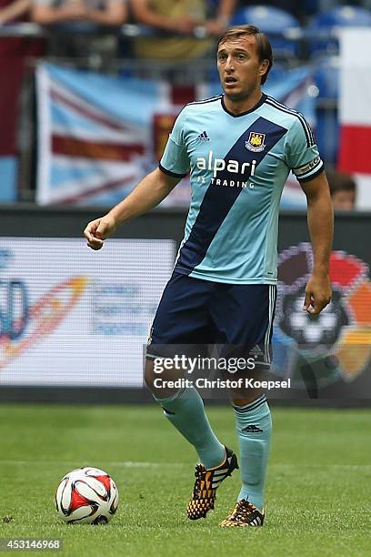 Mark Noble of West Ham United runs with the ball during the match between FC Malaga and West Ham United as part of the Schalke 04 Cup Day at...