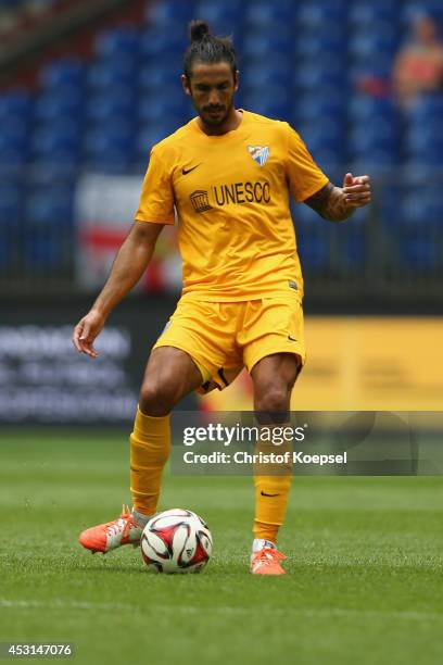 Alberto Angeleri of Malaga runs with the ball during the match between FC Malaga and West Ham United as part of the Schalke 04 Cup Day at...