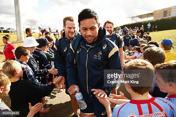 Christian Leali'ifano of the Wallabies greets young fans during an Australian Wallabies training session at Caltex Park on August 4, 2014 in Dubbo,...