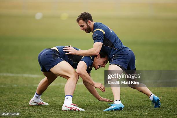 Matt Toomua and Nic White of the Wallabies complete a drill during an Australian Wallabies training session at Caltex Park on August 4, 2014 in...