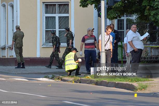 Police and security service experts work outside regional conscription office in the northeastern Ukrainian city of Kharkiv on August 4, 2014....