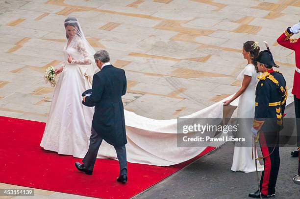 Bride Kate Middleton with her father Michael Middleton and bridesmaid, sister Philippa, walking into Westminster Abbey for the Royal Wedding to HRH...