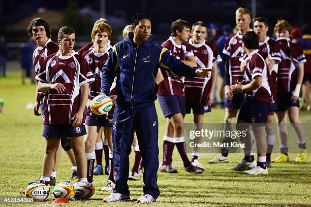 Christian Leali'ifano of the Wallabies coaches young rugby players during an Australian Wallabies coaching clinic on August 4, 2014 in Dubbo,...