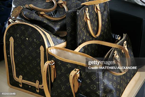 This photo shows pre-owned Luxury bags to be expertised at Instant Luxe office on July 30, 2014 in Paris. Instant Luxe buys and sells authenticated...