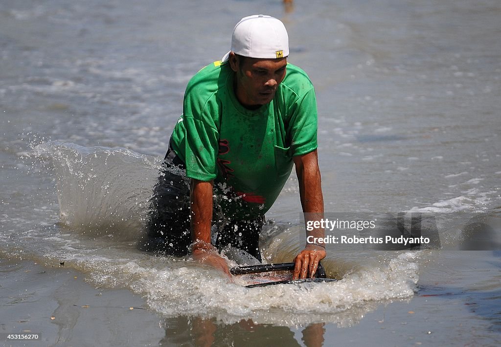 Indonesian Villagers Gather For Traditional Mud Surfing Competition