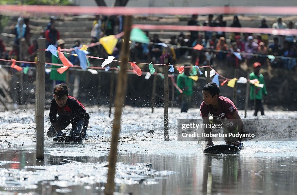 Indonesian Villagers Gather For Traditional Mud Surfing Competition