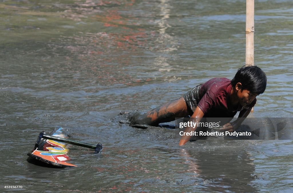 Indonesian Villagers Gather For Traditional Mud Surfing Competition