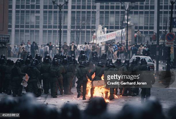 Riot police as they are hit by a Molotov cocktail, during a demonstration in central Seoul. During this period, demonstrations and protests were an...