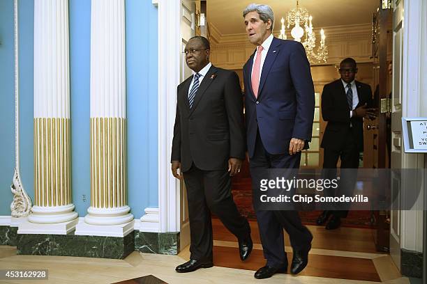 Angola Vice President Manuel Vicente and U.S. Secretary of State John Kerry walk into the Treaty Room before a bilateral meeting during the...