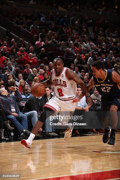 Mike James of the Chicago Bulls drives past Brian Roberts of the New Orleans Pelicans on December 2, 2013 at the United Center in Chicago, Illinois....