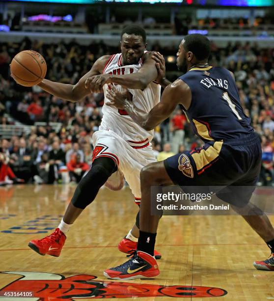 Loul Deng of the Chicago Bulls is shoved by Tyreke Evans of the New Orleans Pelicans at the United Center on December 2, 2013 in Chicago, Illinois....