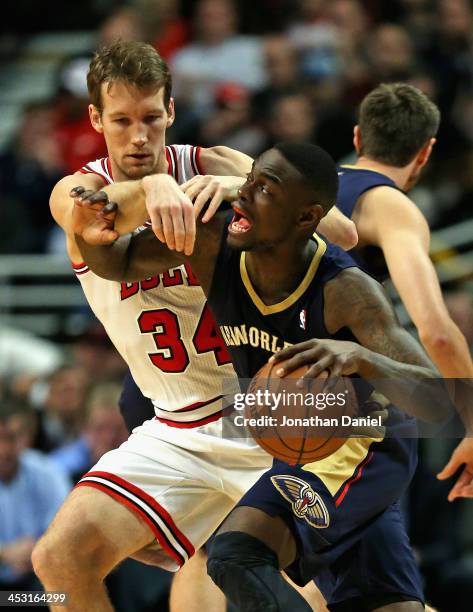 Mike Dunleavy of the Chicago Bulls fouls Anthony Morrow of the New Orleans Pelicans at the United Center on December 2, 2013 in Chicago, Illinois....