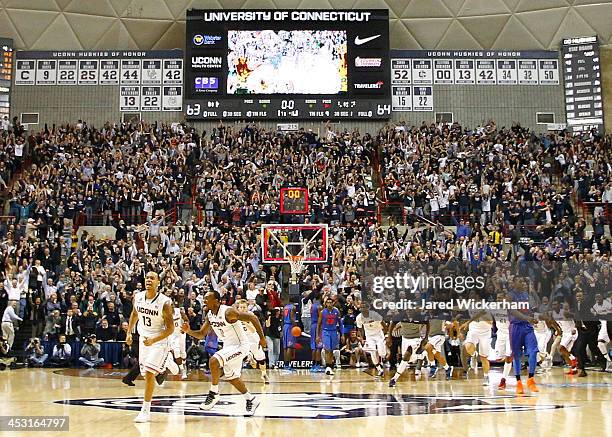 Shabazz Napier of the Connecticut Huskies celebrates following his game-winning shot in the final seconds against the Florida Gators during the game...