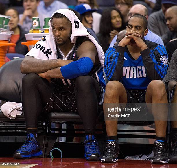 Orlando Magic power forward Glen Davis , left and Orlando Magic shooting guard Arron Afflalo sit on the bench in the final moments of their game...