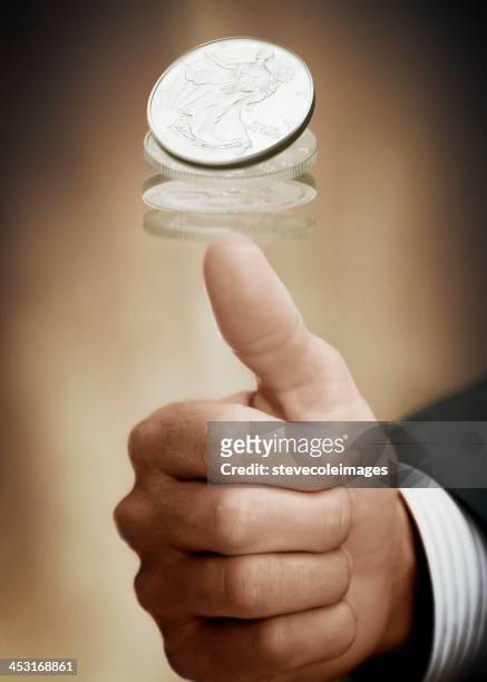 flipping a coin - flipping a coin stock pictures, royalty-free photos & images
