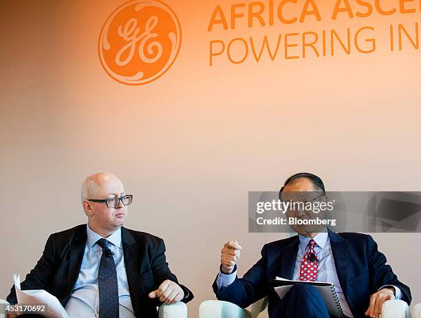 Matthew Bishop, of The Economist, left, listens to Jim Yong Kim, president of the World Bank Group, during a forum on African energy and innovation...