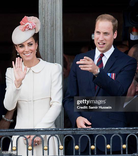 Catherine, Duchess of Cambridge and Prince William, Duke of Cambridge look on from the balcony of the town hall as they attend a reception at the...
