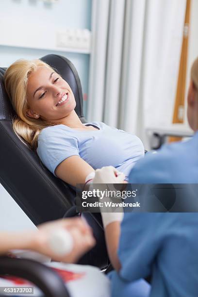 patient giving her blood - blood donation bildbanksfoton och bilder