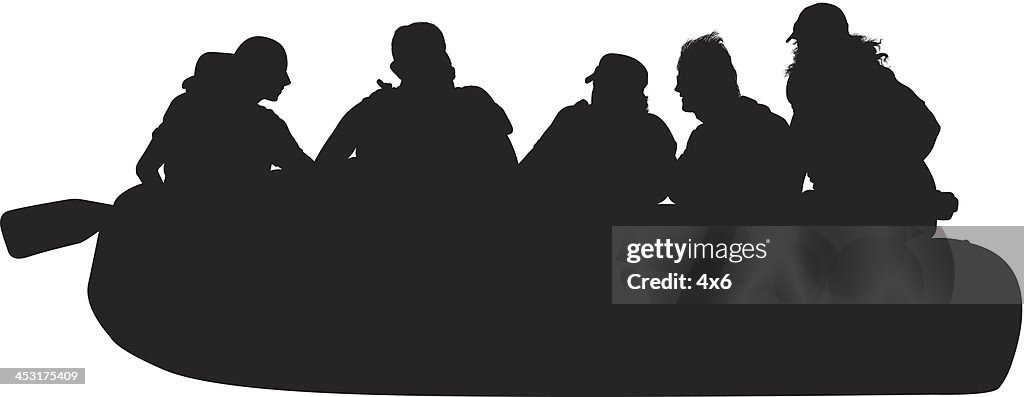 Silhouette of people rafting