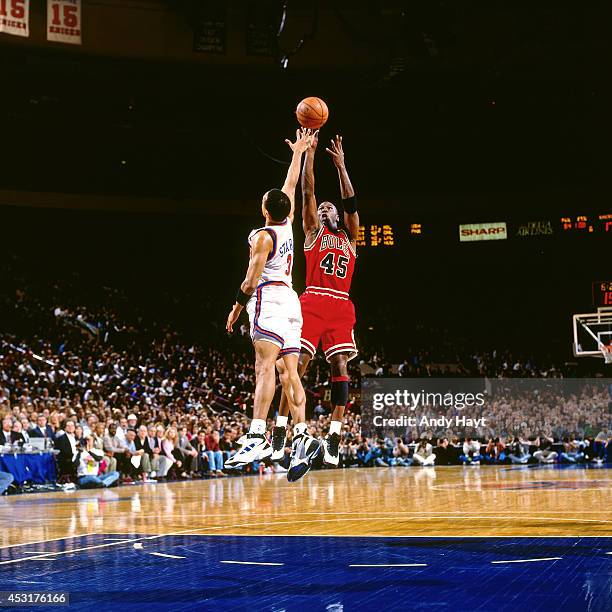 Michael Jordan of the Chicago Bulls shoots against John Starks of the New York Knicks on March 28, 1995 at Madison Square Garden in New York City....