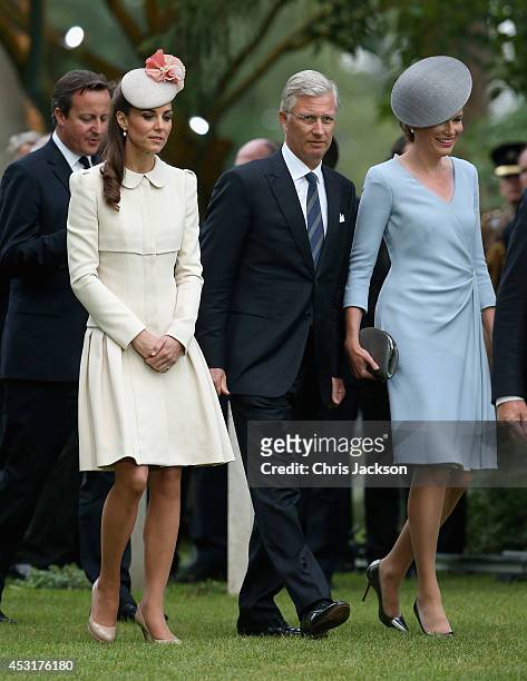 Catherine, Duchess of Cambridge walks with King Philippe of Belgium and Queen Matilde of Belgium past war graves at St Symphorien Military Cemetery...