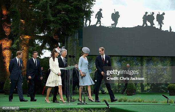 Prince Harry talks to British Prime Minister David Cameron whilst Catherine, Duchess of Cambridge walks with King Philippe of Belgium and Prince...