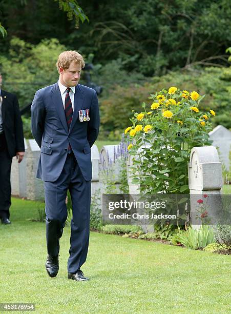 Prince Harry looks at war graves at St Symphorien Military Cemetery on August 4, 2014 in Mons, Belgium. Monday 4th August marks the 100th Anniversary...