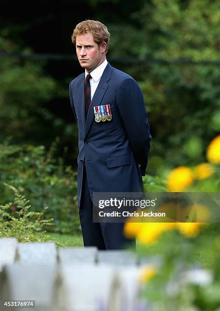 Prince Harry looks at war graves at St Symphorien Military Cemetery on August 4, 2014 in Mons, Belgium. Monday 4th August marks the 100th Anniversary...