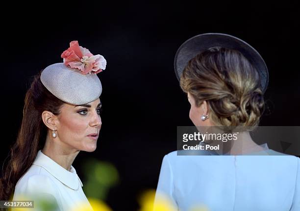 Catherine, Duchess of Cambridge and speaks with Queen Mathilde of Belgium during a ceremony at St. Symphorien Military Cemetery on August 4, 2014 in...