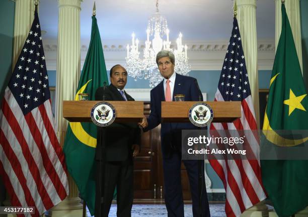 President of Mauritania Mohamed Ould Abdel Aziz and U.S. Secretary of State John Kerry shake hands before a bilateral meeting during the U.S.-Africa...