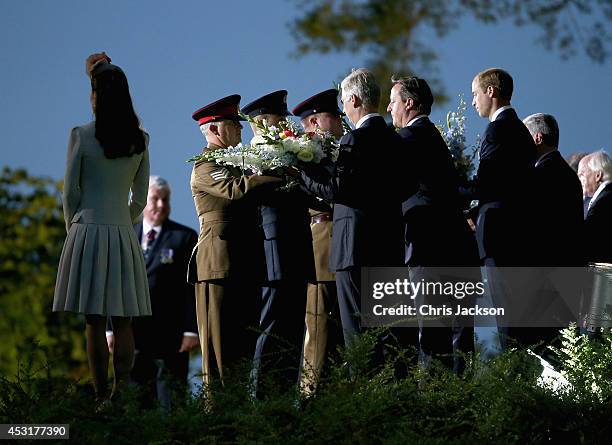 Catherine, Duchess of Cambridge , King Philippe of Belgium, Prime Minister David Cameron and Prince William, Duke of Cambridge pay their respects at...