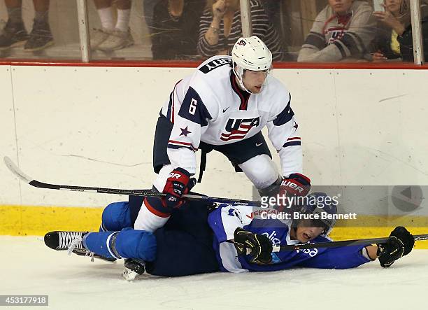 Jack Dougherty of USA White hits Hannes Bjorninen of Team Finland during the 2014 USA Hockey Junior Evaluation Campat Lake Placid Olympic Center on...