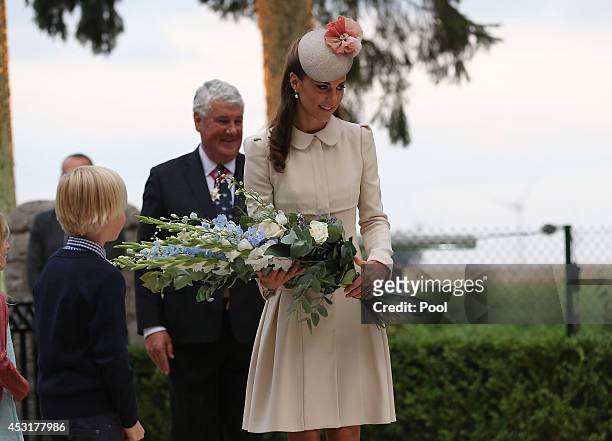 Catherine, Duchess of Cambridge lays flowers during a ceremony at St Symphorien Military Cemetery on August 4, 2014 in Mons, Belgium. Monday 4th...