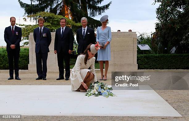 Catherine, Duchess of Cambridge is watched by Prince William, Duke of Cambridge, Prince Harry, British Prime Minister David Cameron, King Phillipe of...