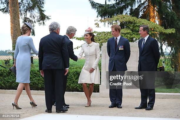 Catherine, Duchess of Cambridge greets King Philippe of Belgium, as Prince Harry and British Prime Minister David Cameron during a ceremony at St...