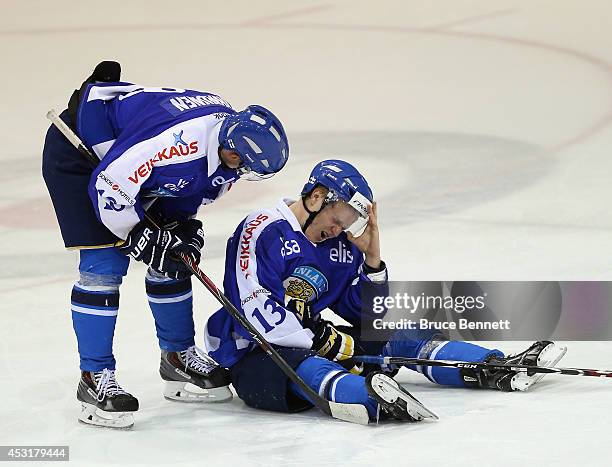Joel Janatuinen of Team Finland lies on the ice following a hit by Mike McCarron during the third period in the 2014 USA Hockey Junior Evaluation...