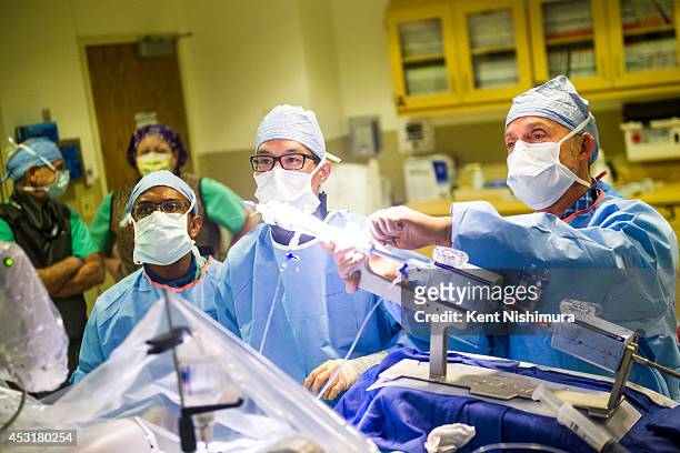 Dr. Kalkidan Biahu, Dr. Mike Kim, and Dr. John Carroll perform a minimally invasive surgery at one of the University of Colorado Hospital's catheter...